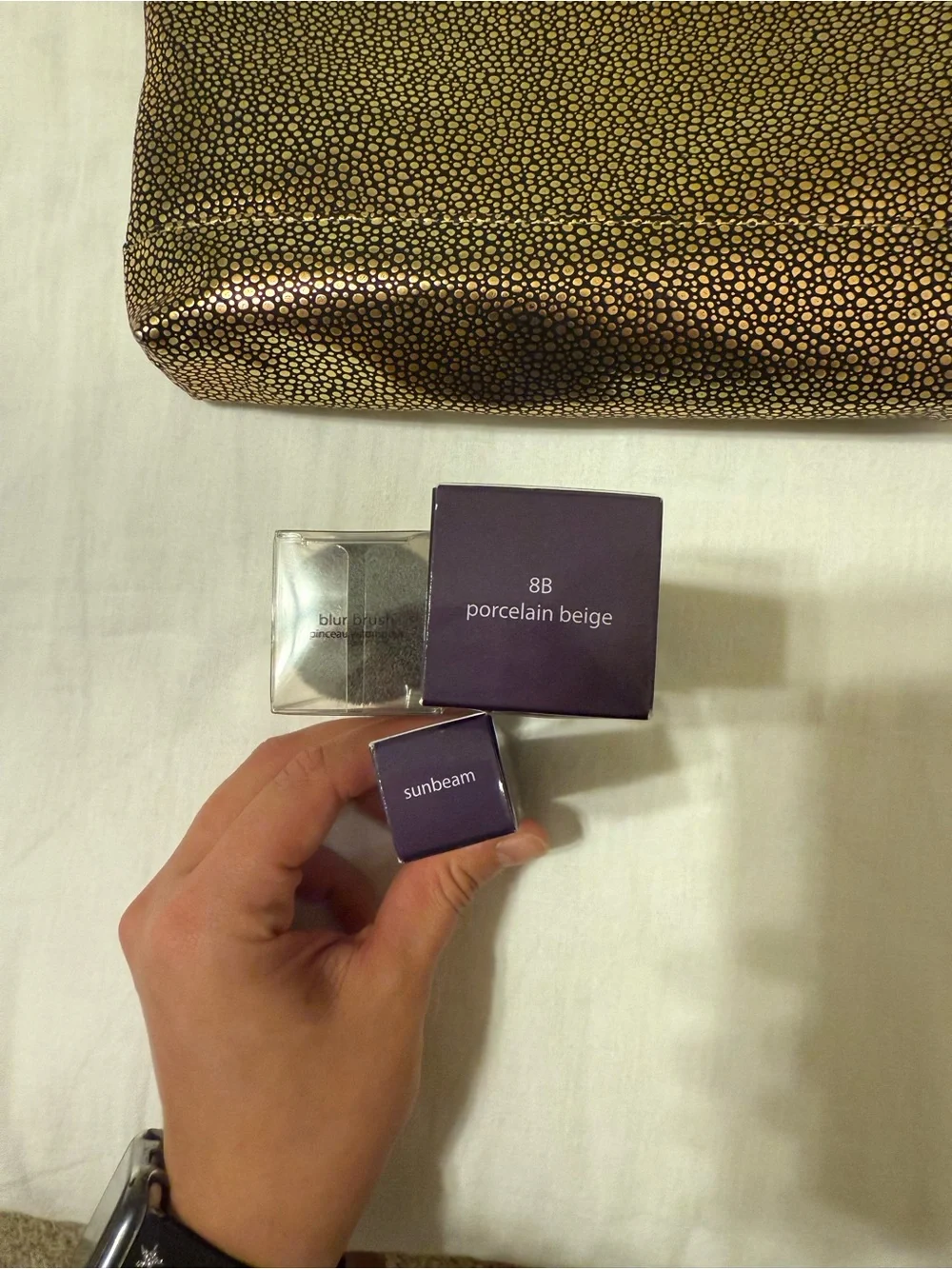 tarte makeup minis in purple packaging with gold-speckled pouch